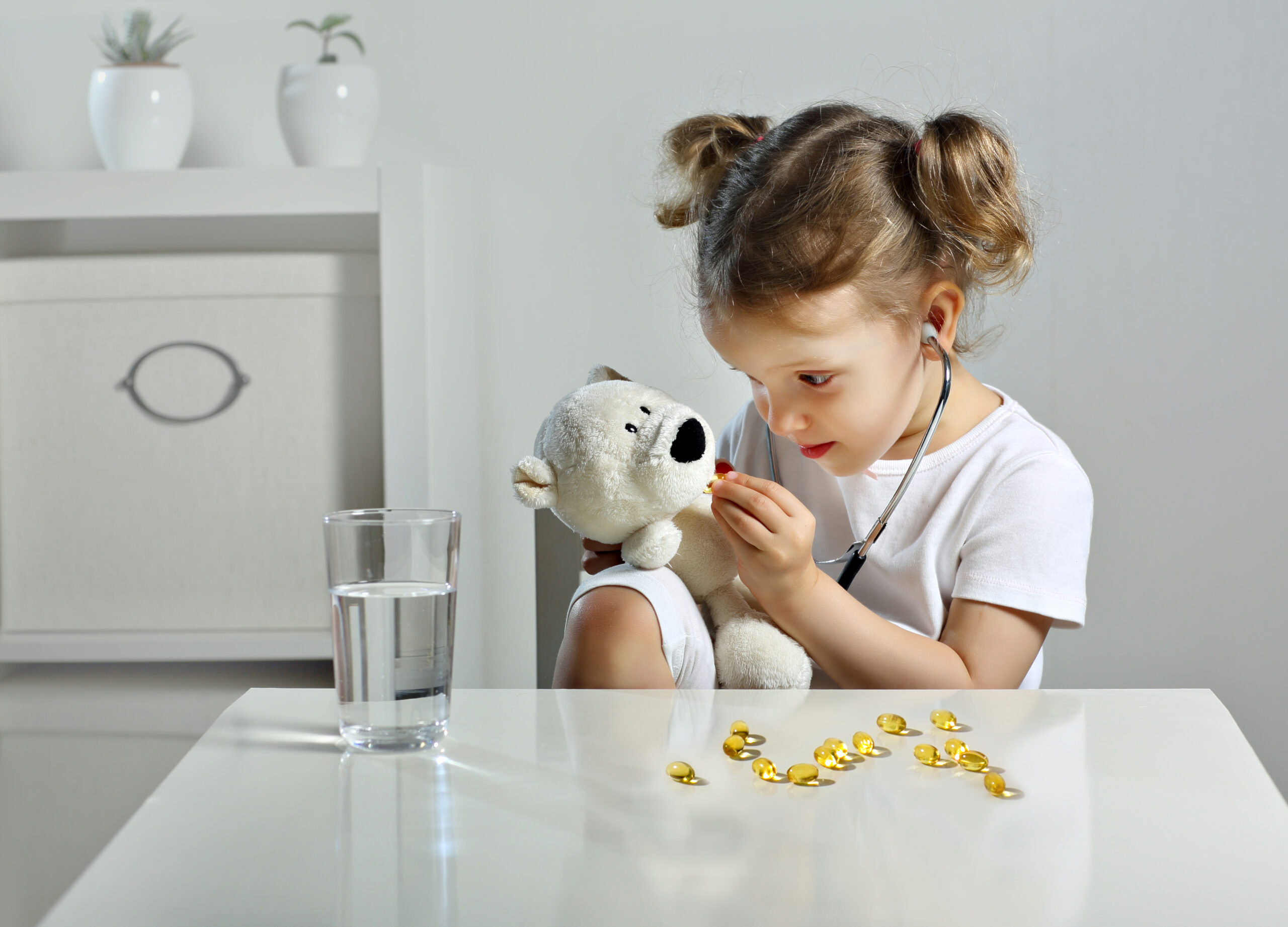 girl playing with teddy bear and learning supplements for kids