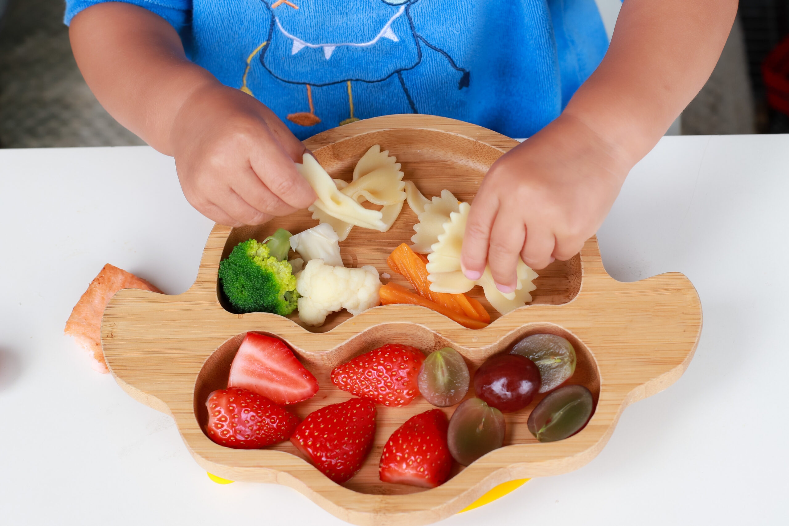child eating veggies with pasta finger foods 17 ways to add vegetables to meals for kids